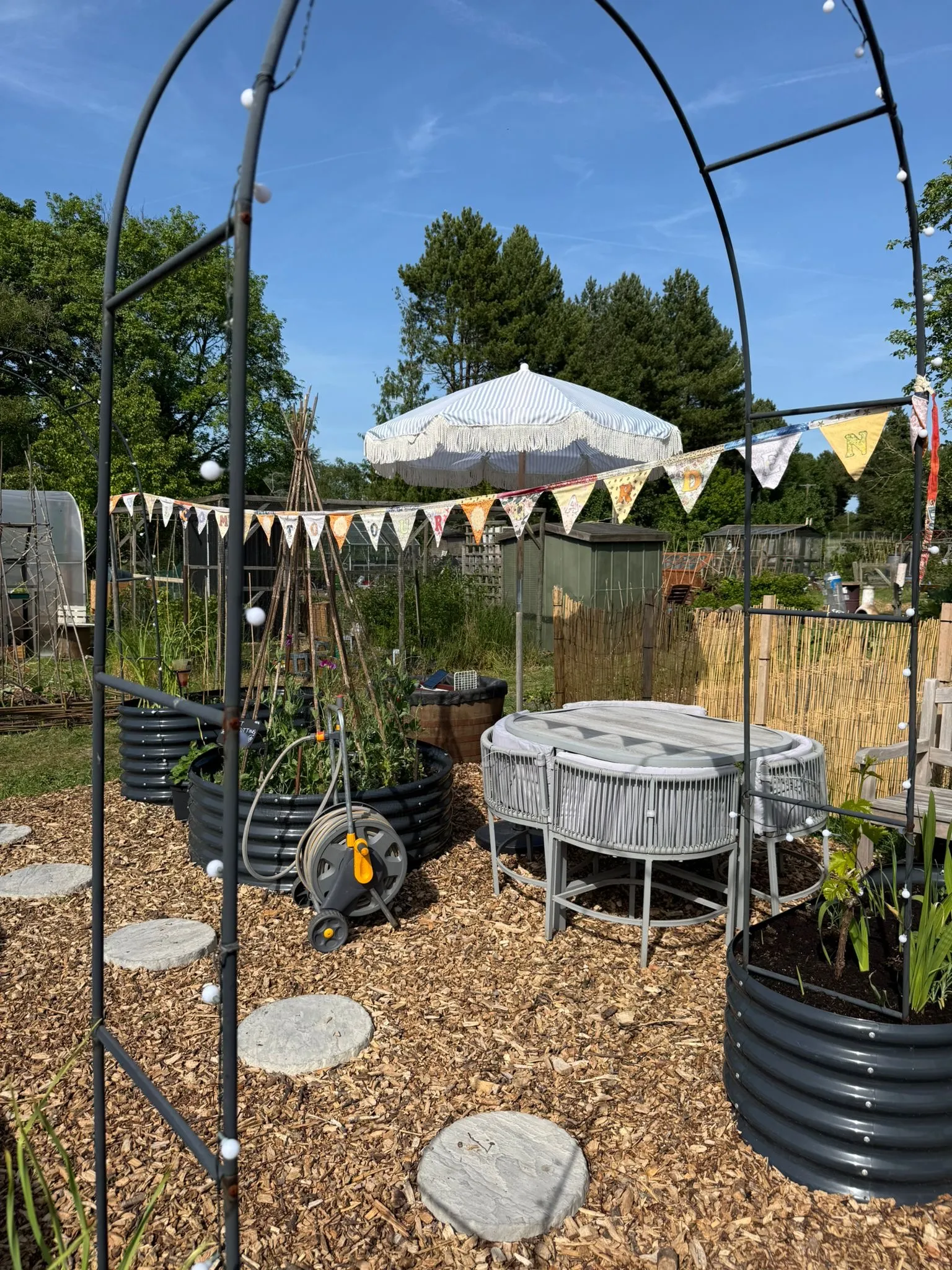 The HEG Grows plot at East Hendred Allotments, with raised beds, bunting and seating